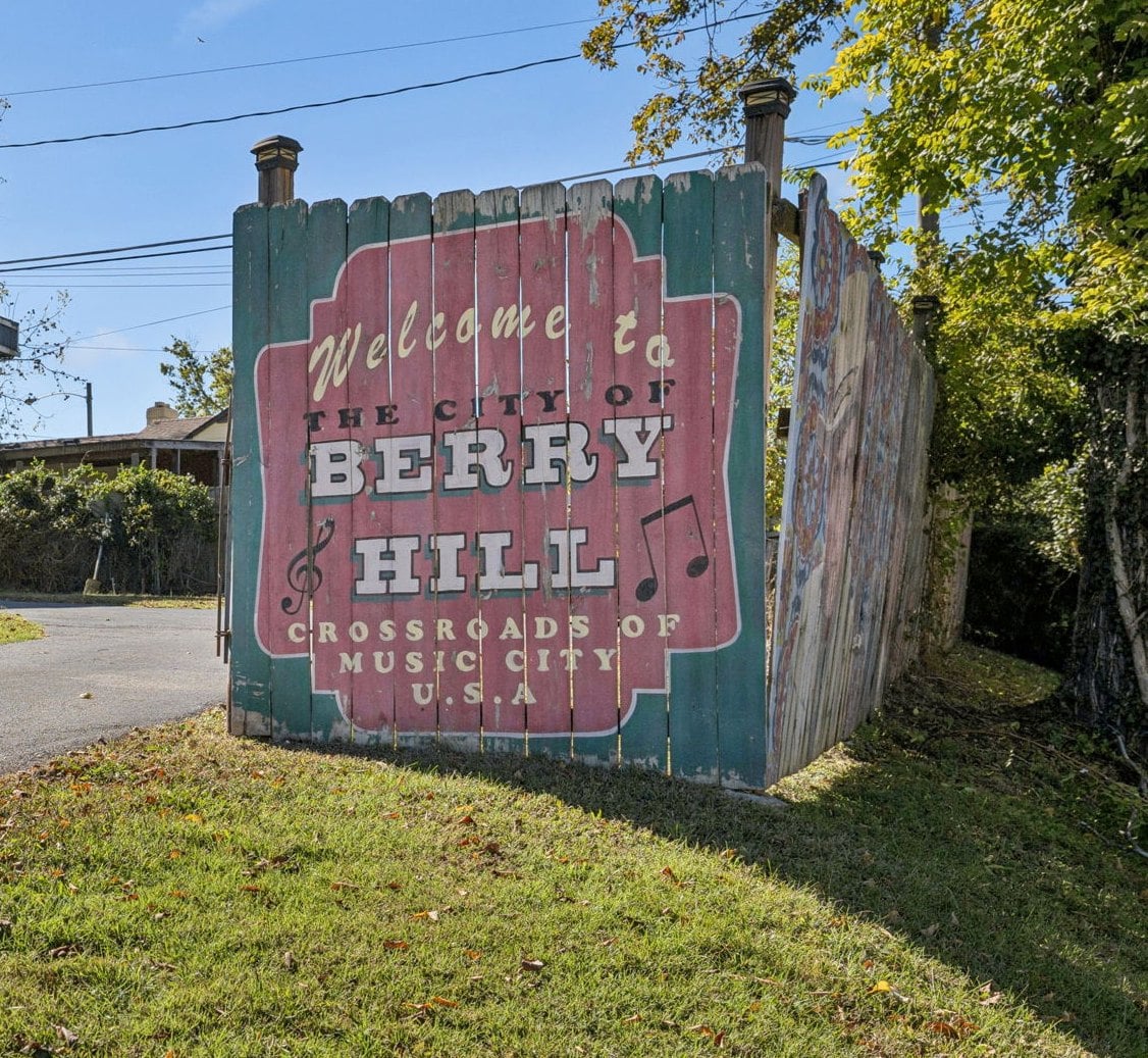 Painted wooden Welcome to the City of Berry Hill sign beside a driveway in Davidson County, Tennessee