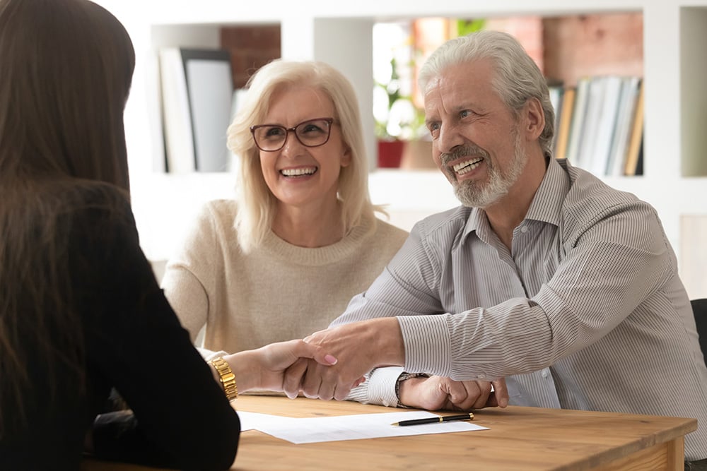 People,Sit,At,Desk,In,Office,Focus,On,Aged,Couple