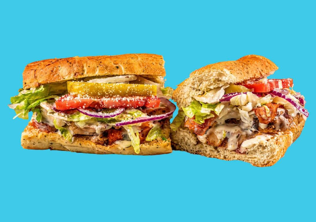 Two loaded Cheba Hut toasted subs with fresh vegetables