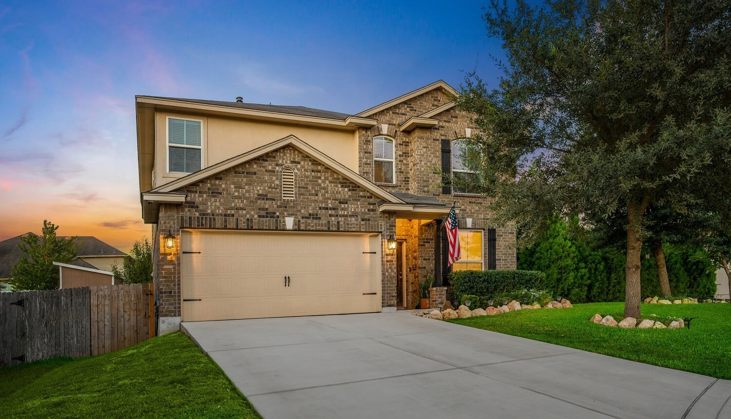 a home at sunset with a green yard