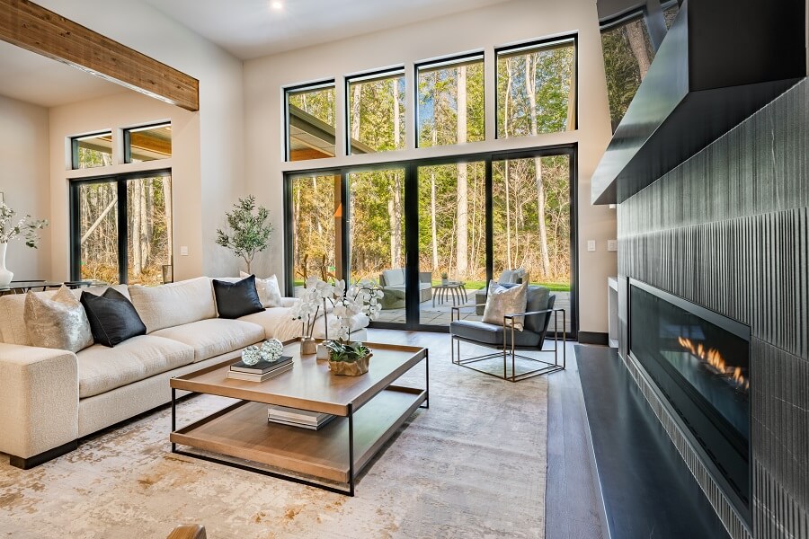 room with staging and stainless appliances deep sink grey cabinets