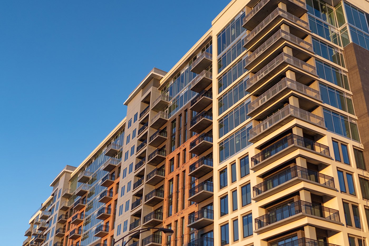 Modern,Apartment,Building,On,Blue,Sky,At,Sunrise