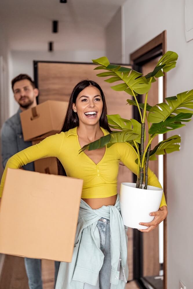 Young couple holding cardboard boxes