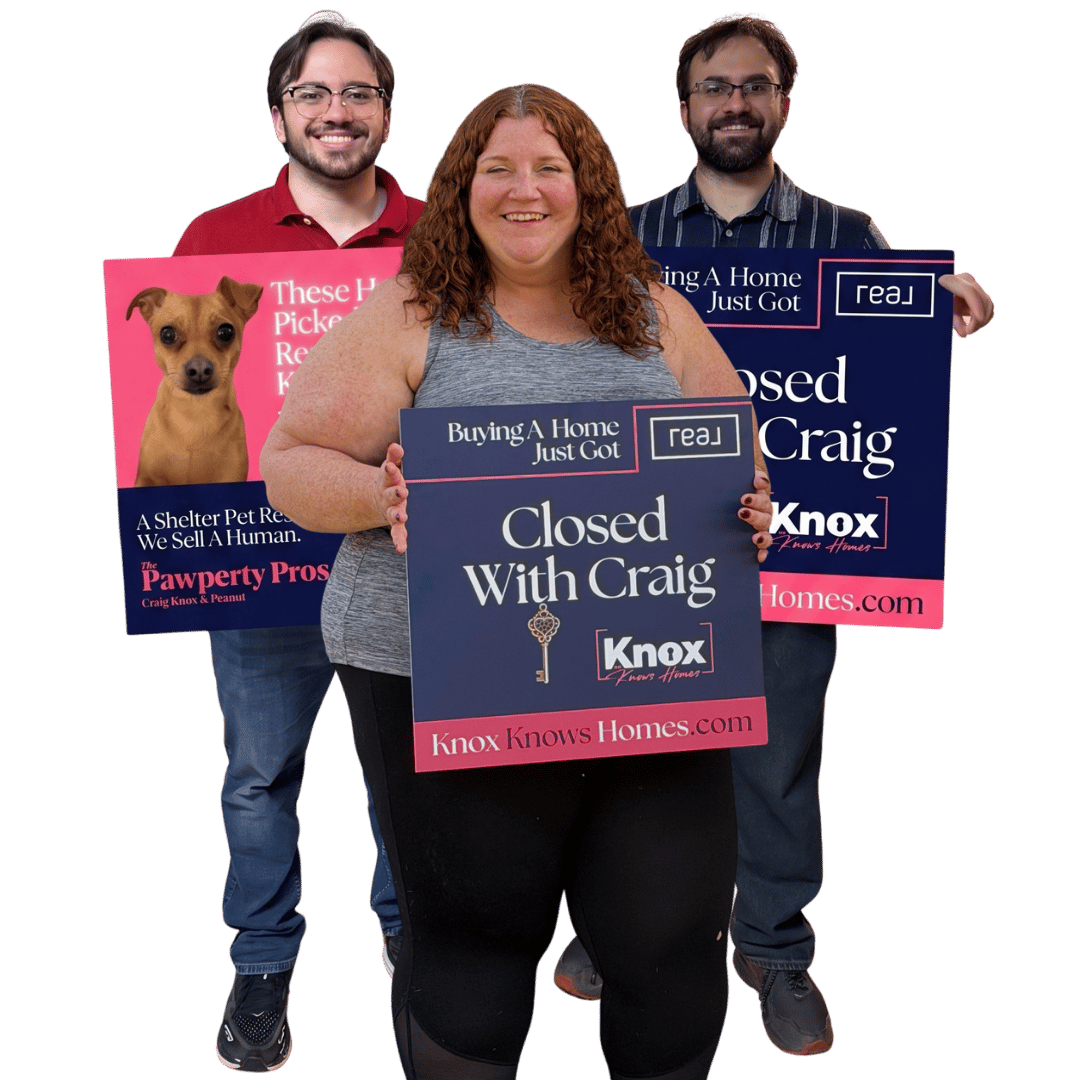 New home buyers holding closing signs celebrating their first home.