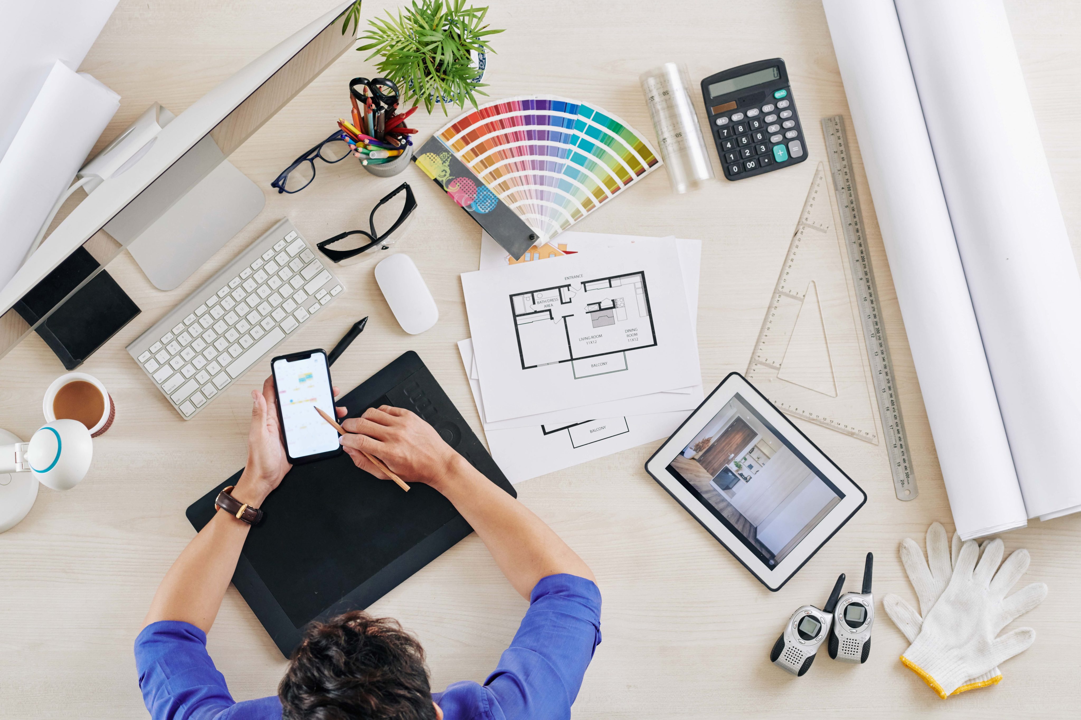 Freelance interior designer checking messages from clients in his smartphone