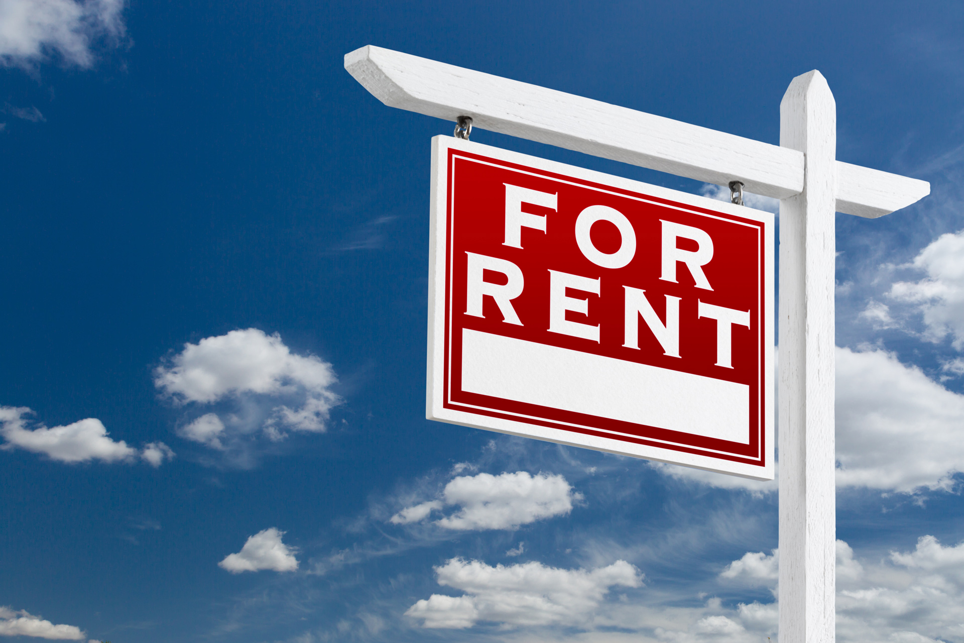 Left-Facing-For-Rent-Real-Estate-Sign-Over-Blue-Sky-and-Clouds-With-Room-For-Your-Text.