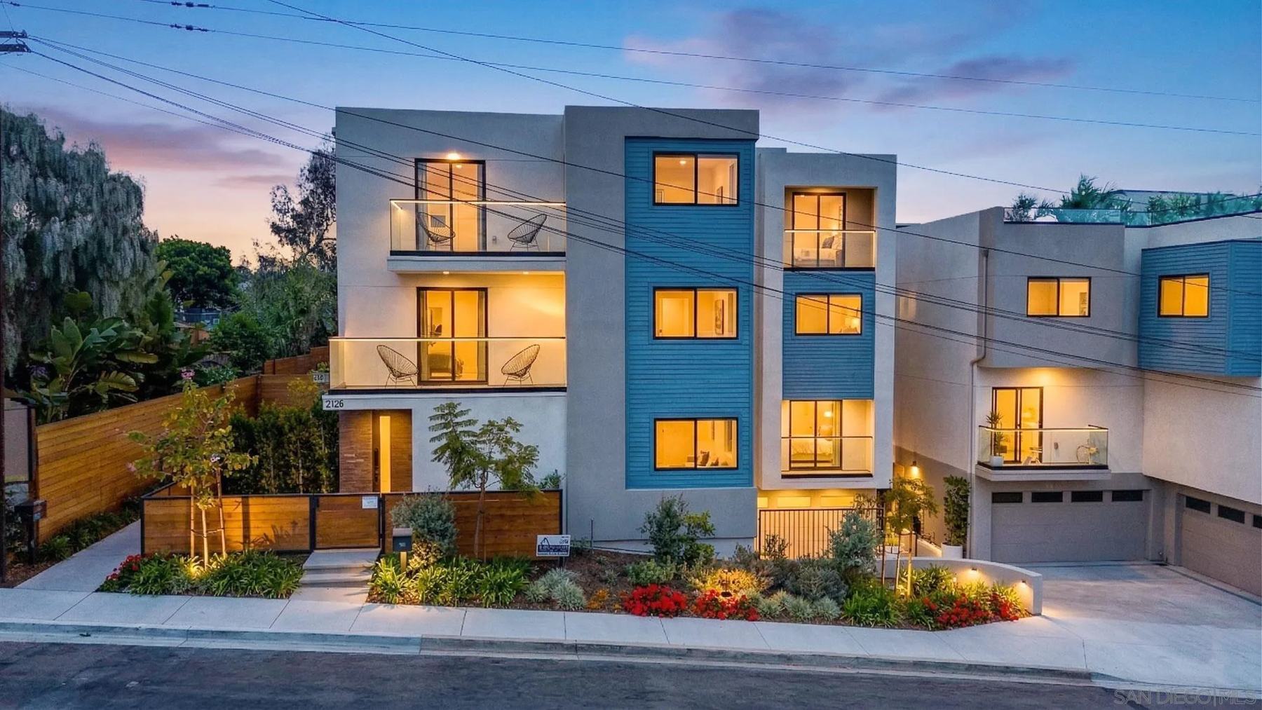 The same Point Loma townhomes at twilight with every window lit