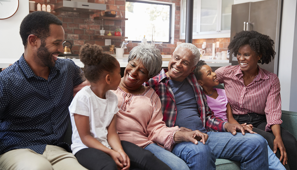 Multi Generation Family Relaxing On Sofa At Home Together