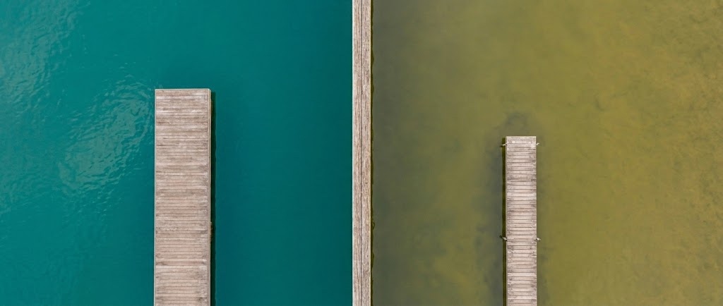 Waterfront docks with different water conditions in Kemptville Ontario showing property value differences in the real estate market