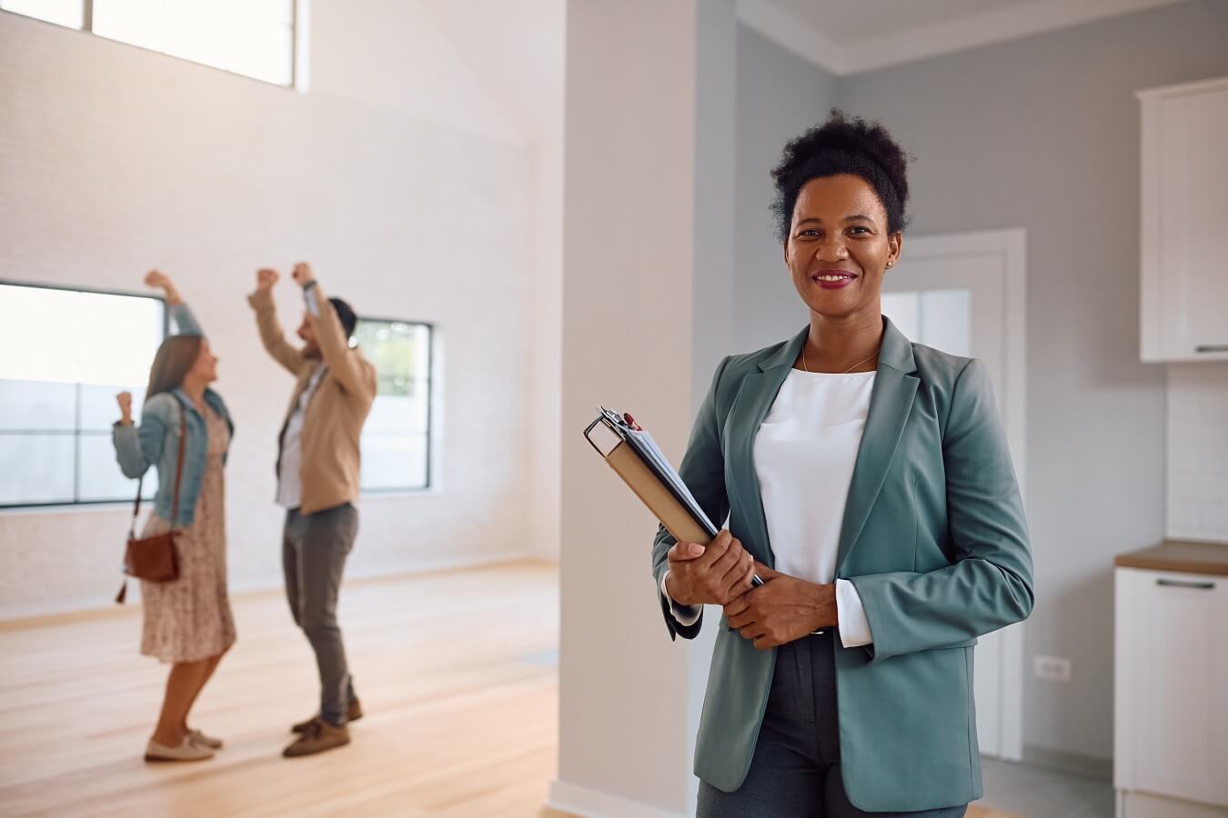 real estate agent with couple dancing out