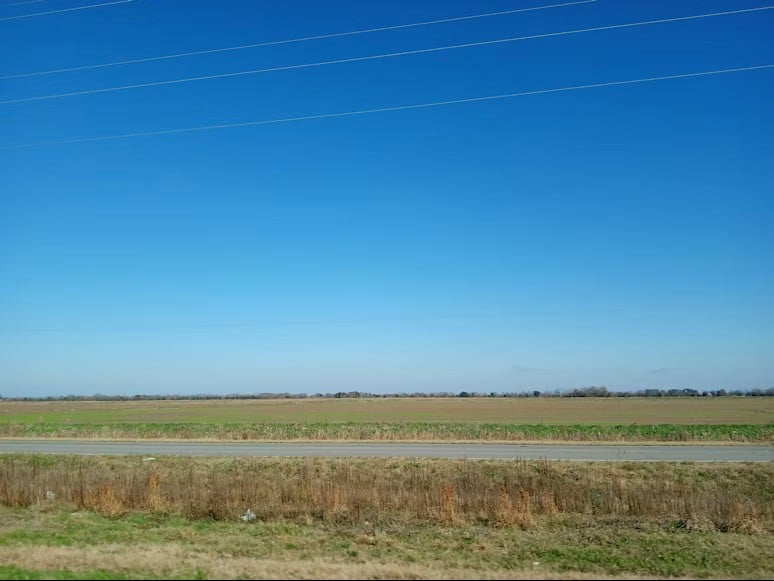 Imagery of an empty road in the middle of a field