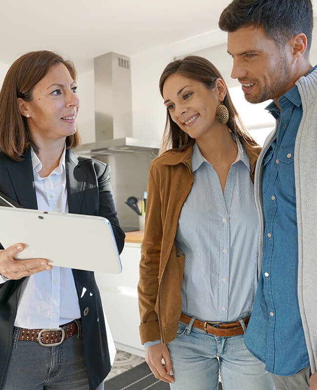 Couple-with-real-estate-agent-visiting-house-for-sale