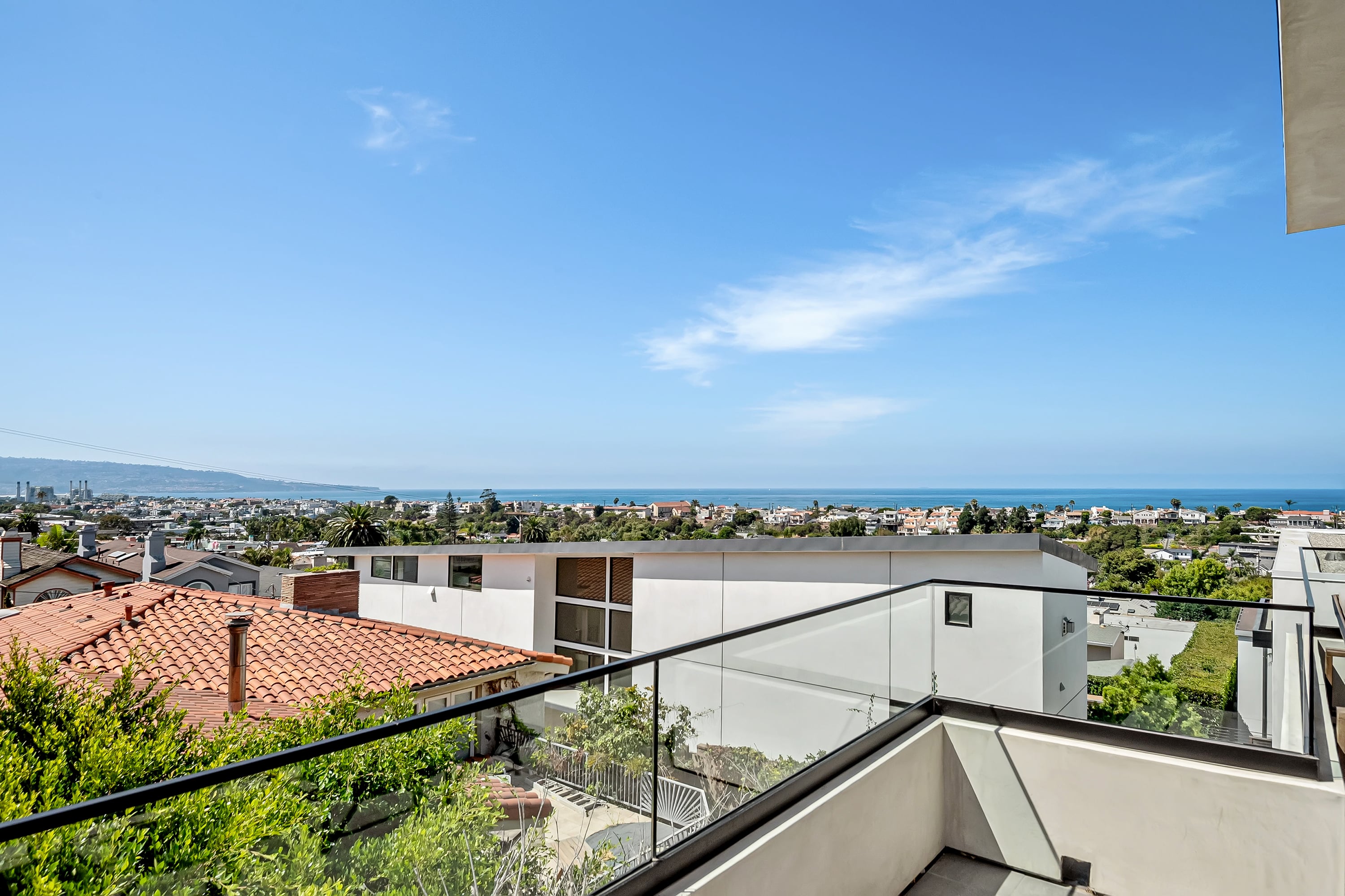 Elevated view across Hermosa Beach homes toward the Pacific Ocean
