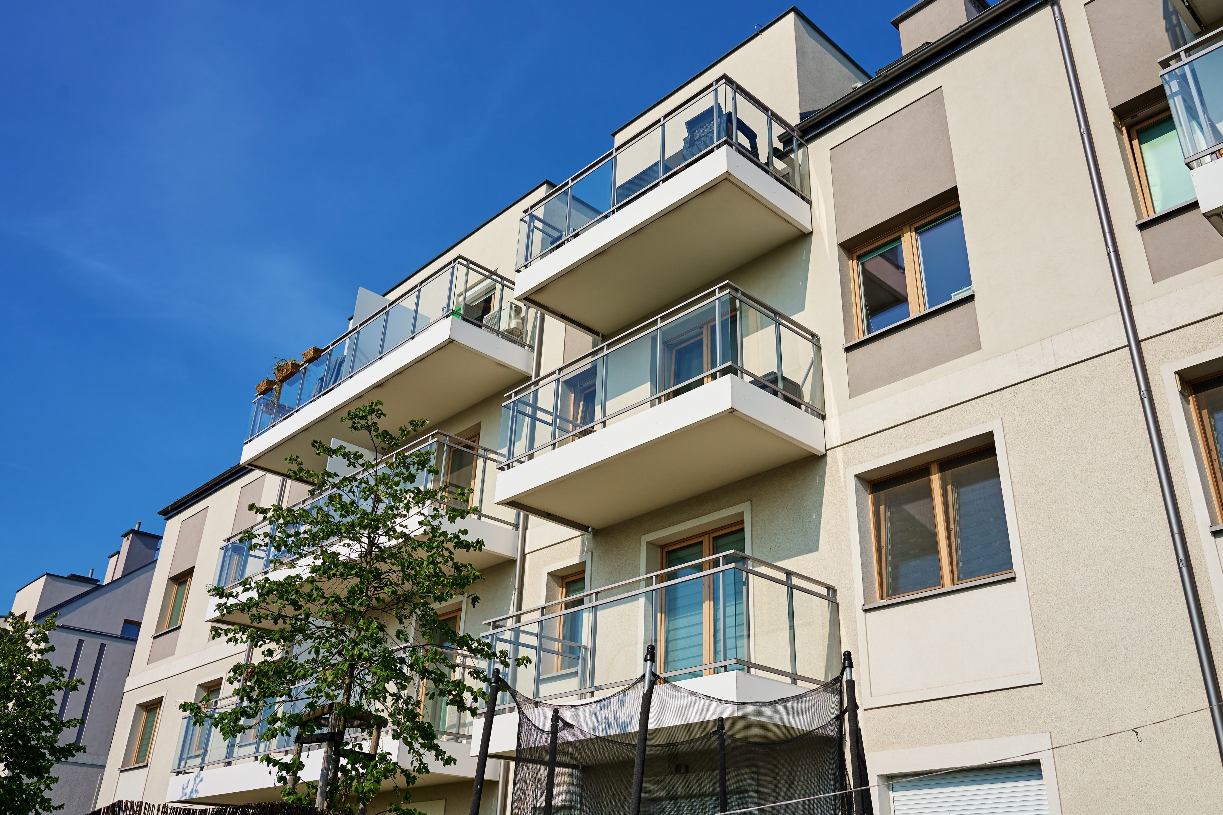 Modern apartment building with balconies on sunny day