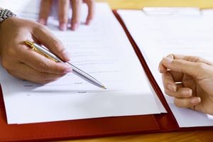 Real estate agent showing tenant where to sign contract