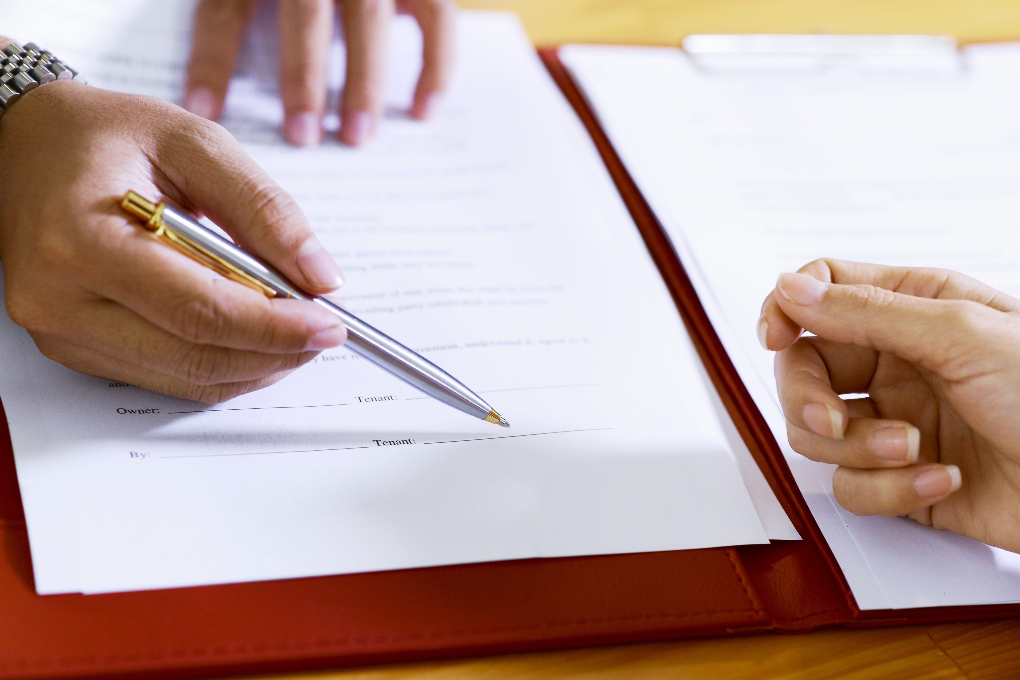 Real estate agent showing tenant where to sign contract