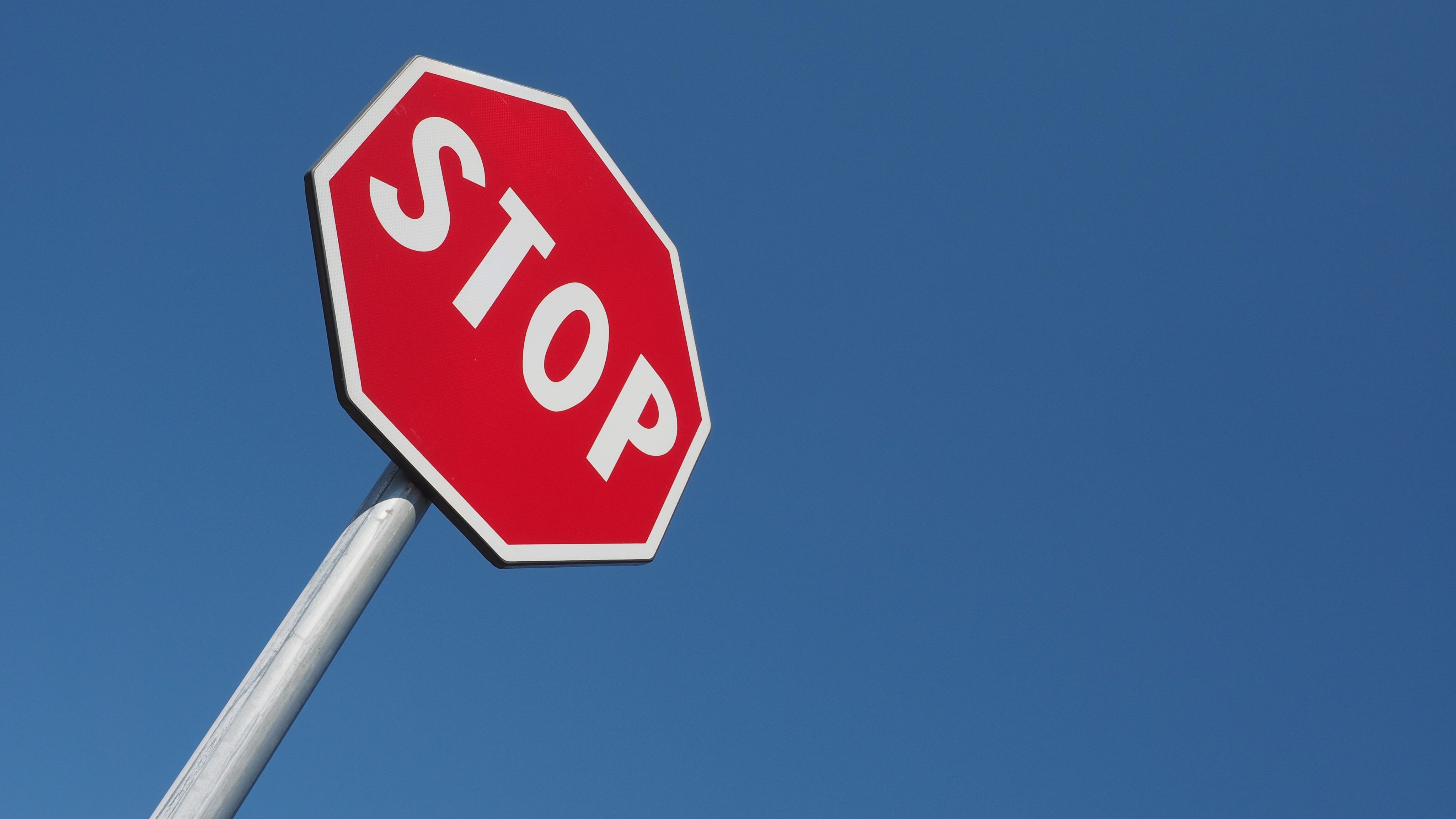 Warning signs, stop traffic sign over blue sky