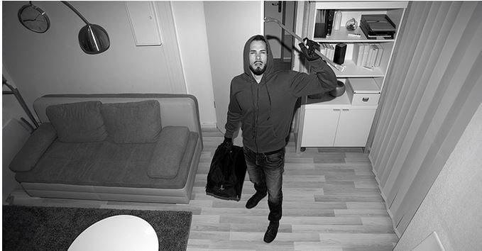 Person taking a photo in a monochrome indoor setting