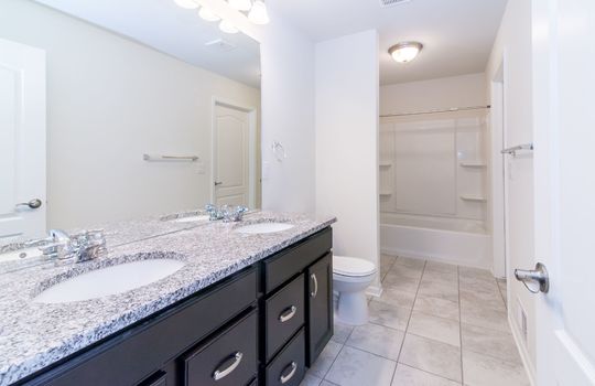 image depicts a spacious and well-lit modern bathroom, likely within a residential property such as an apartment, house, or vacation rental