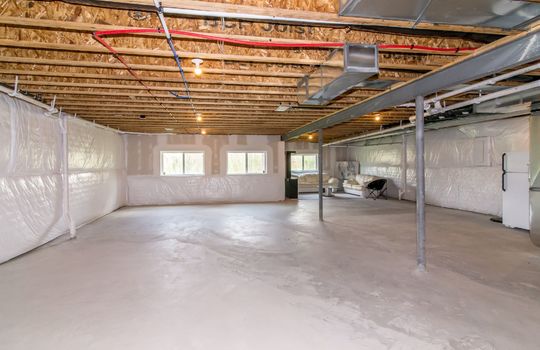 The image shows the unfinished basement of a house