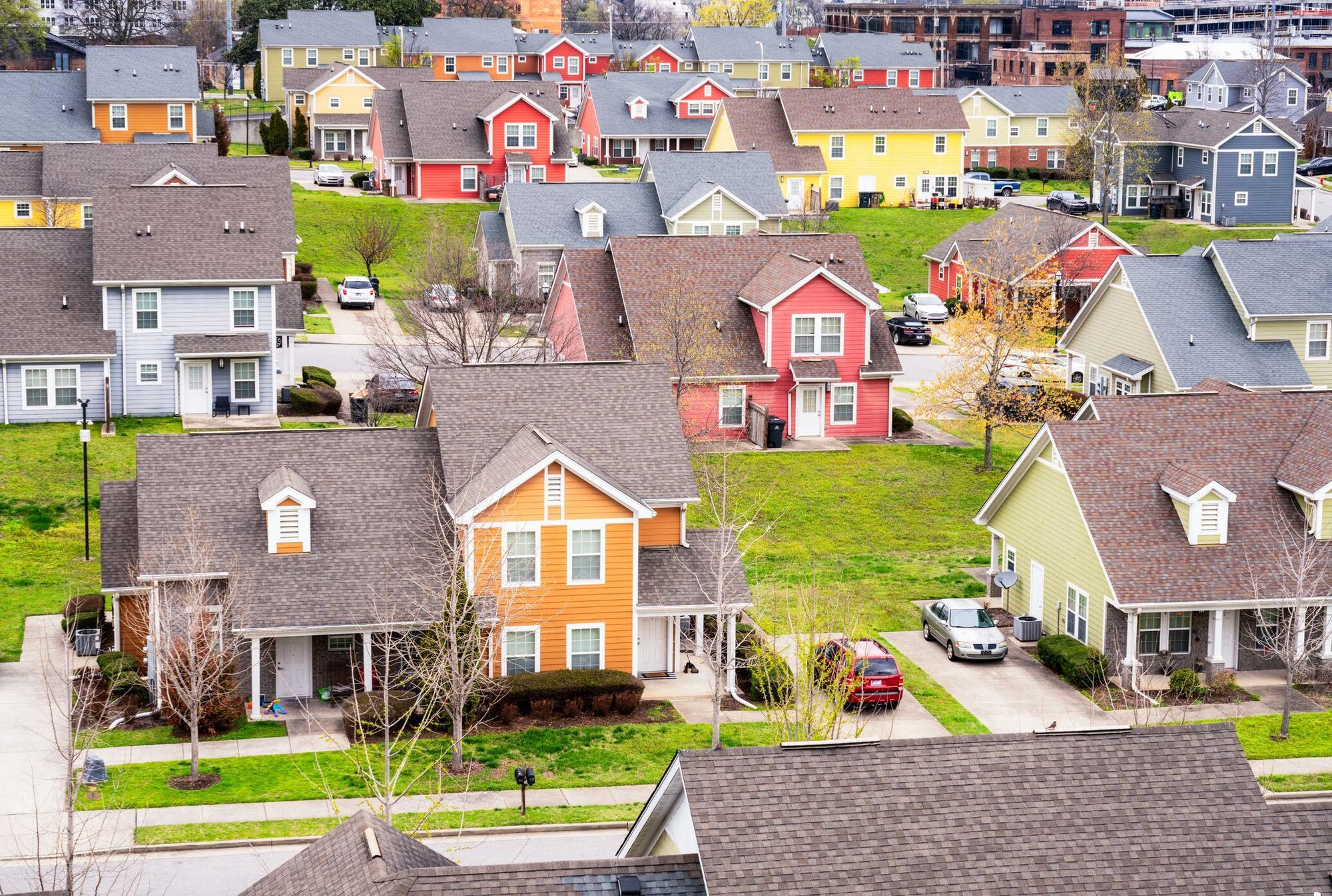 image shows a residential neighborhood with houses in various colors and architectural styles