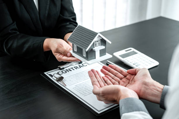 image depicts a contract signing, likely for a property purchase