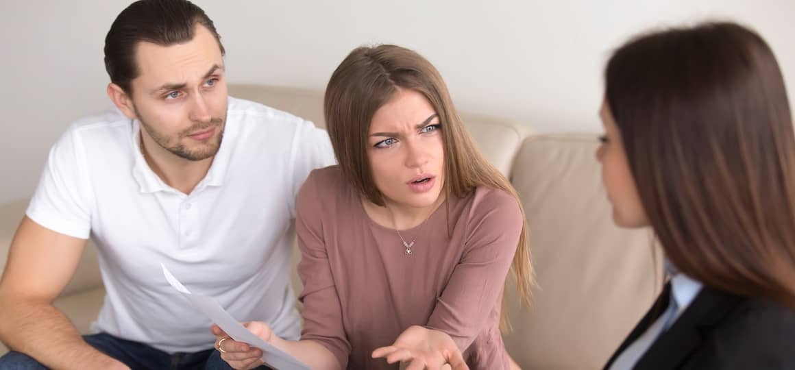 image shows a tense discussion between a couple and a third person, possibly a professional consultant or advisor