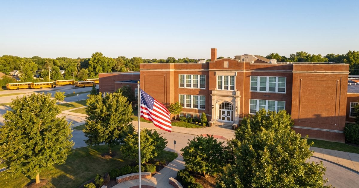 Aerial view of a Michigan public school building with American flag