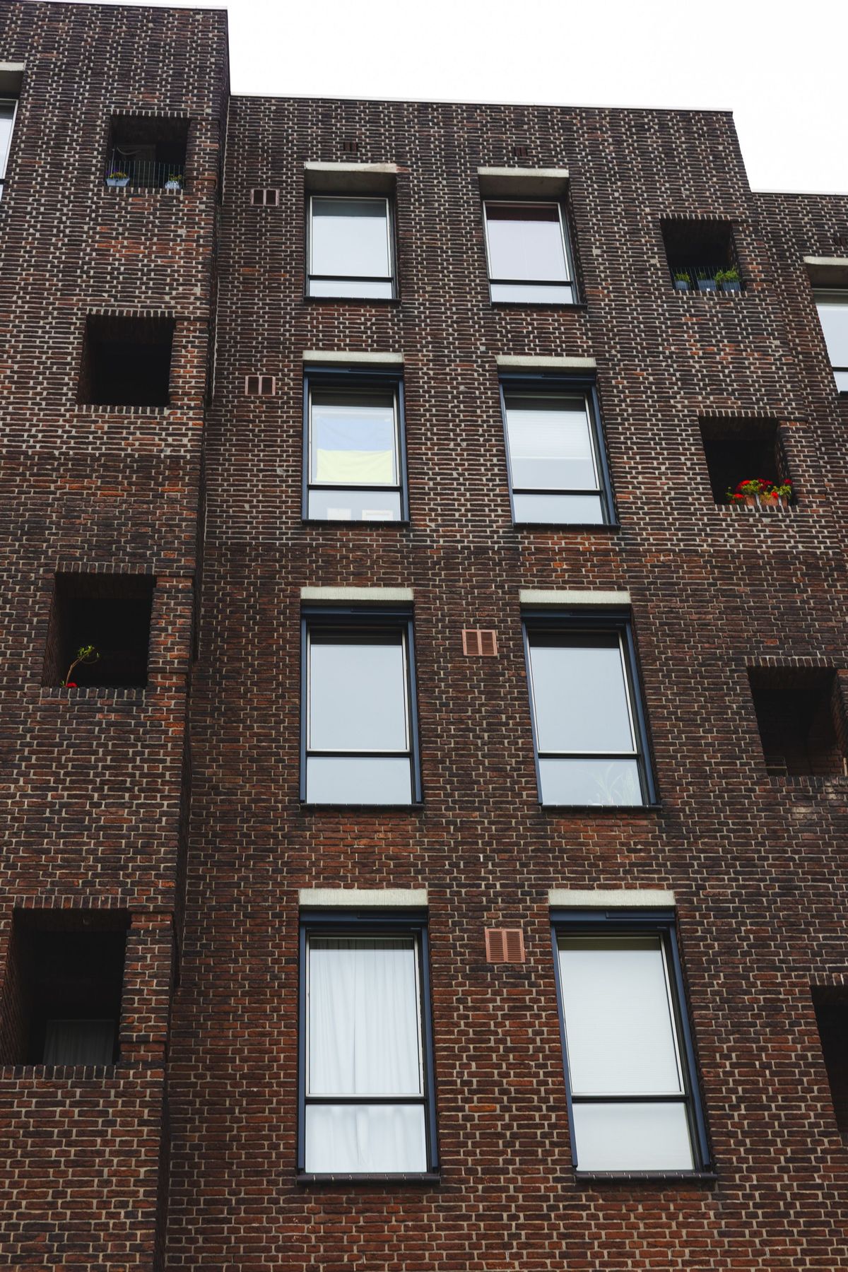Multi-story brick condo building with balconies, the type of community often governed by an HOA