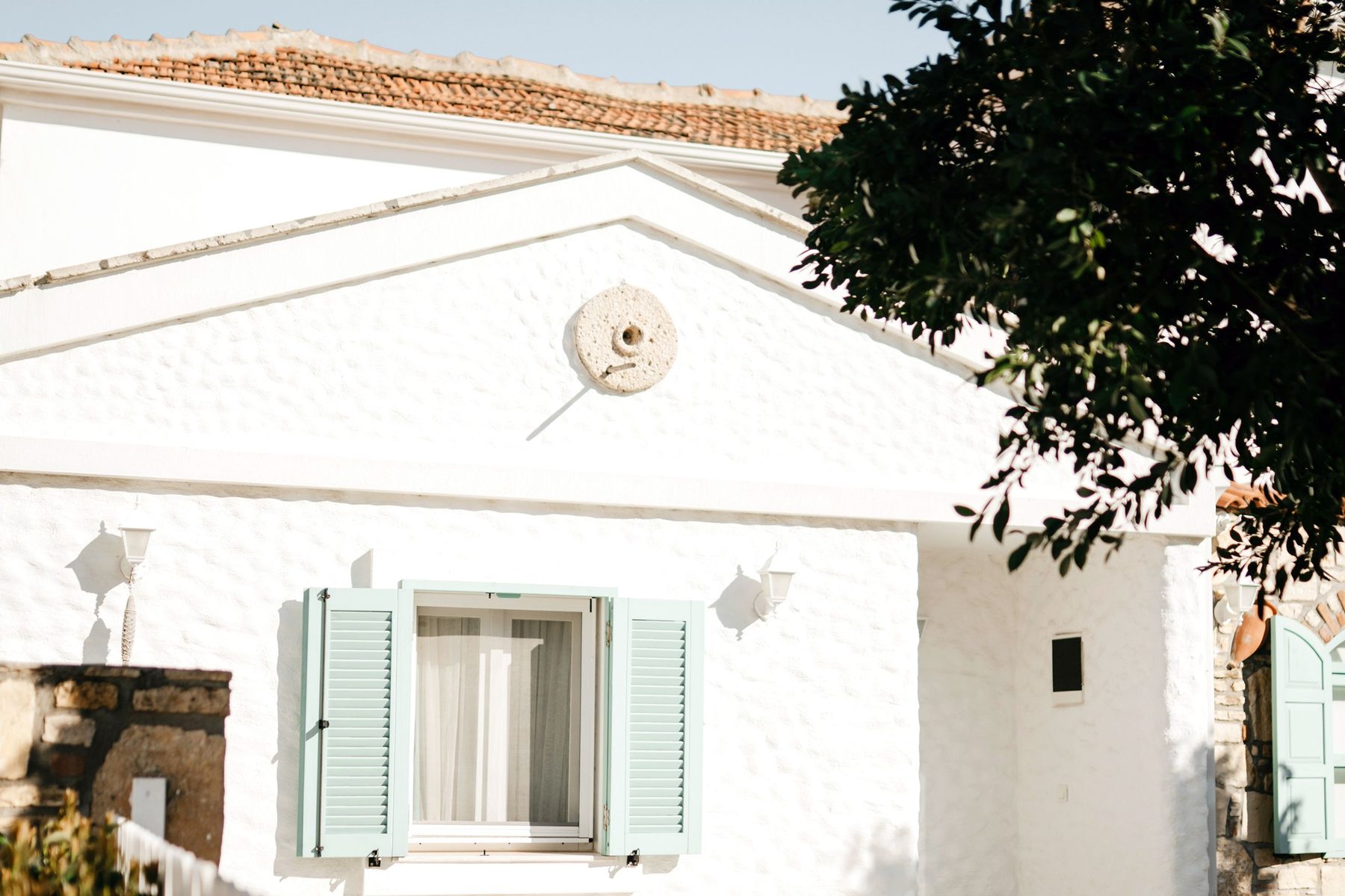White home with mint-green shutters and a terracotta tile roof, the kind of starter home first-time buyers in San Diego County look for