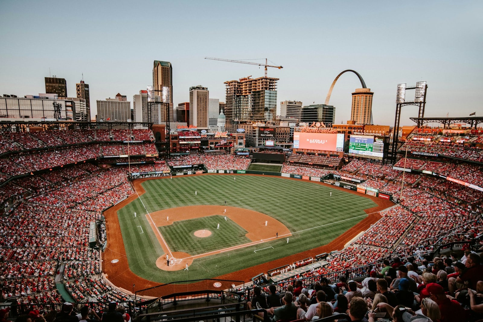 Busch Stadium in St. Louis full of Cardinals fans with the Gateway Arch in the background