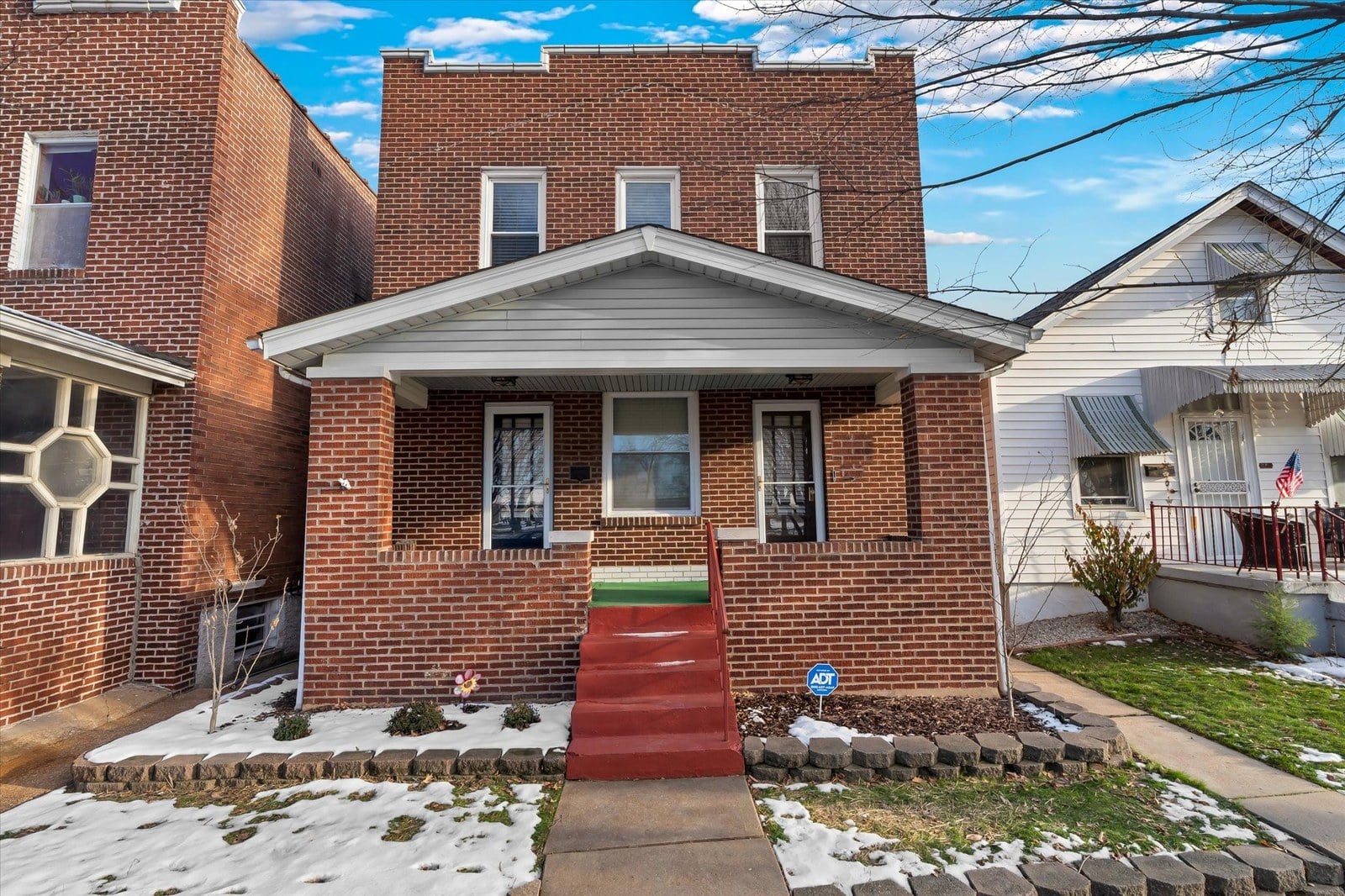 Brick two-family flat in South St. Louis with two front doors and a covered front porch