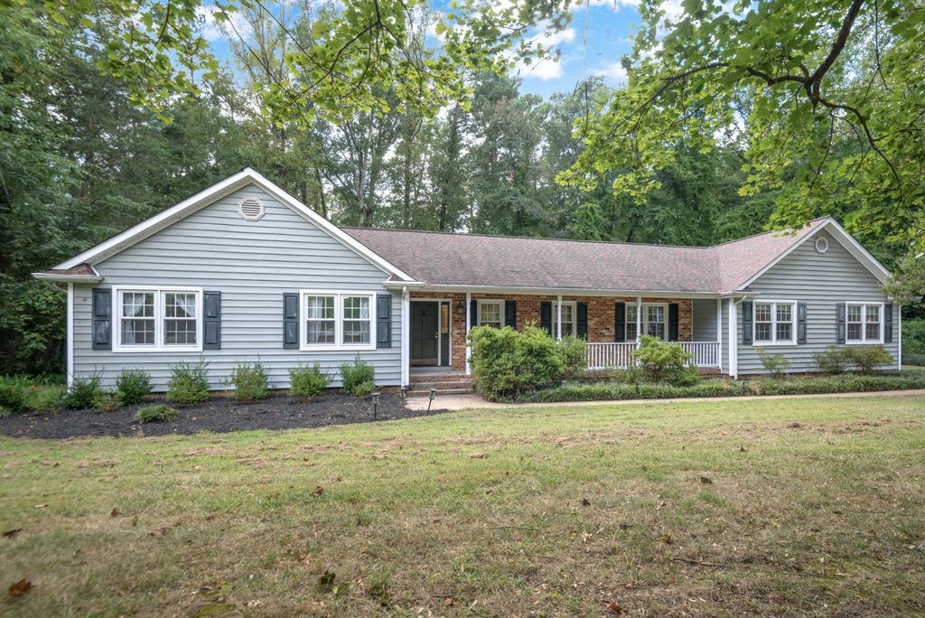 A brick and siding ranch home under mature trees in Rock Spring Estates, Glen Allen, Virginia