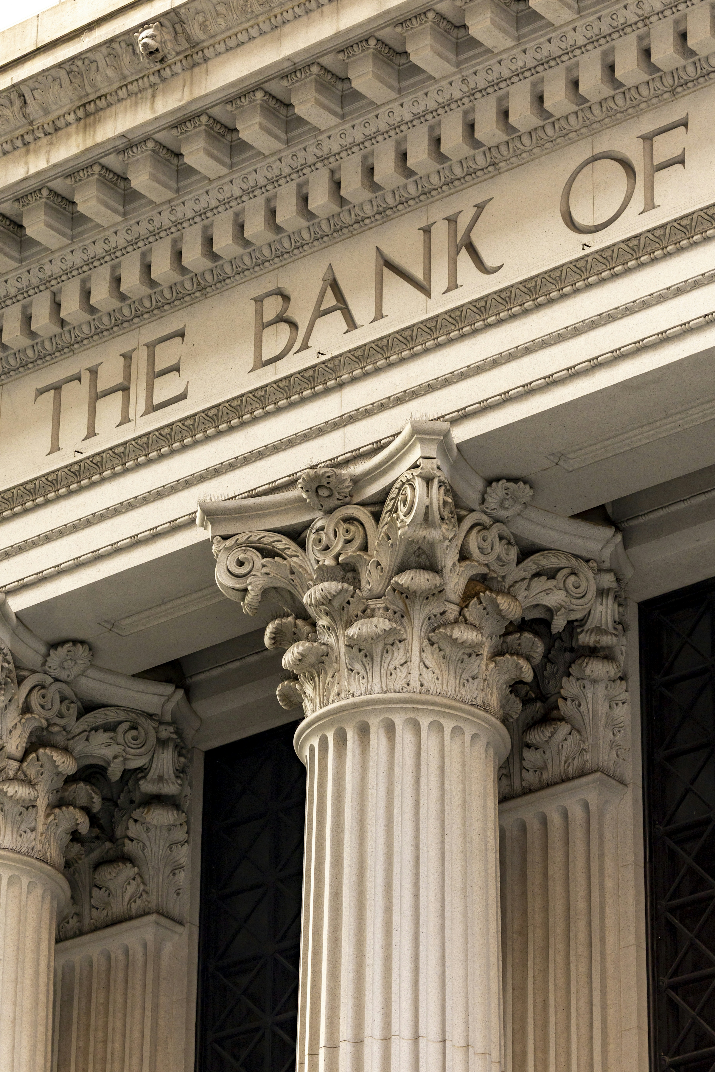 Ornate classical columns across the stone facade of an old bank building