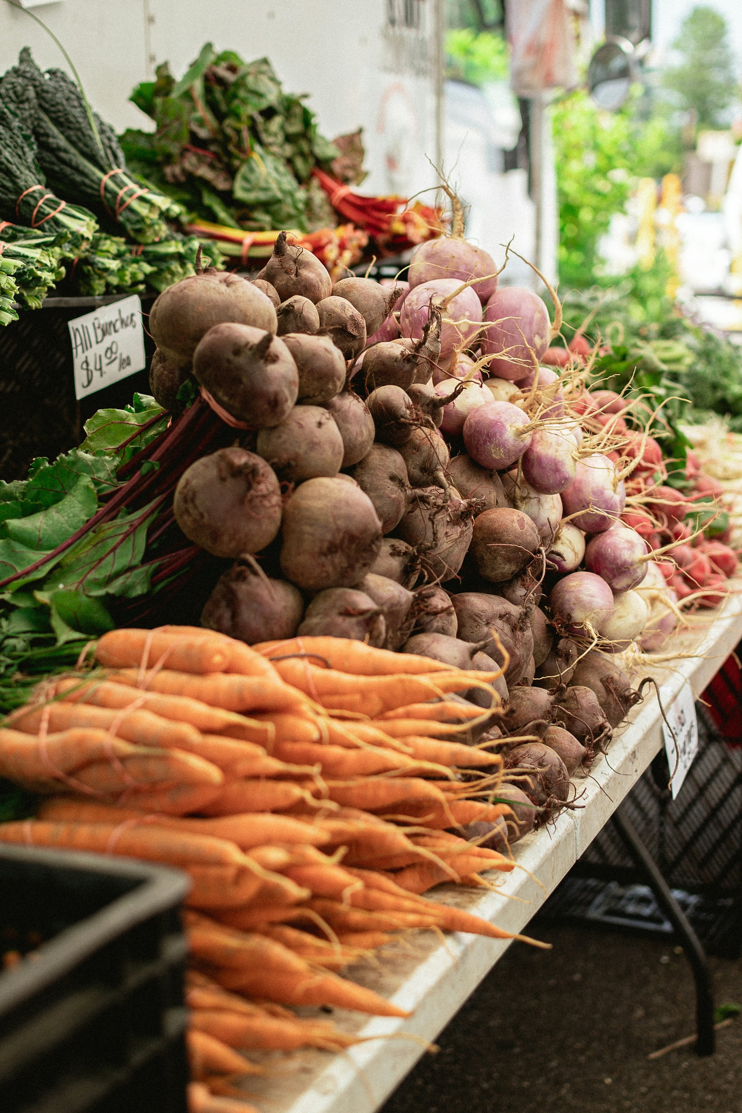 Root vegetables displayed at an outdoor market stall