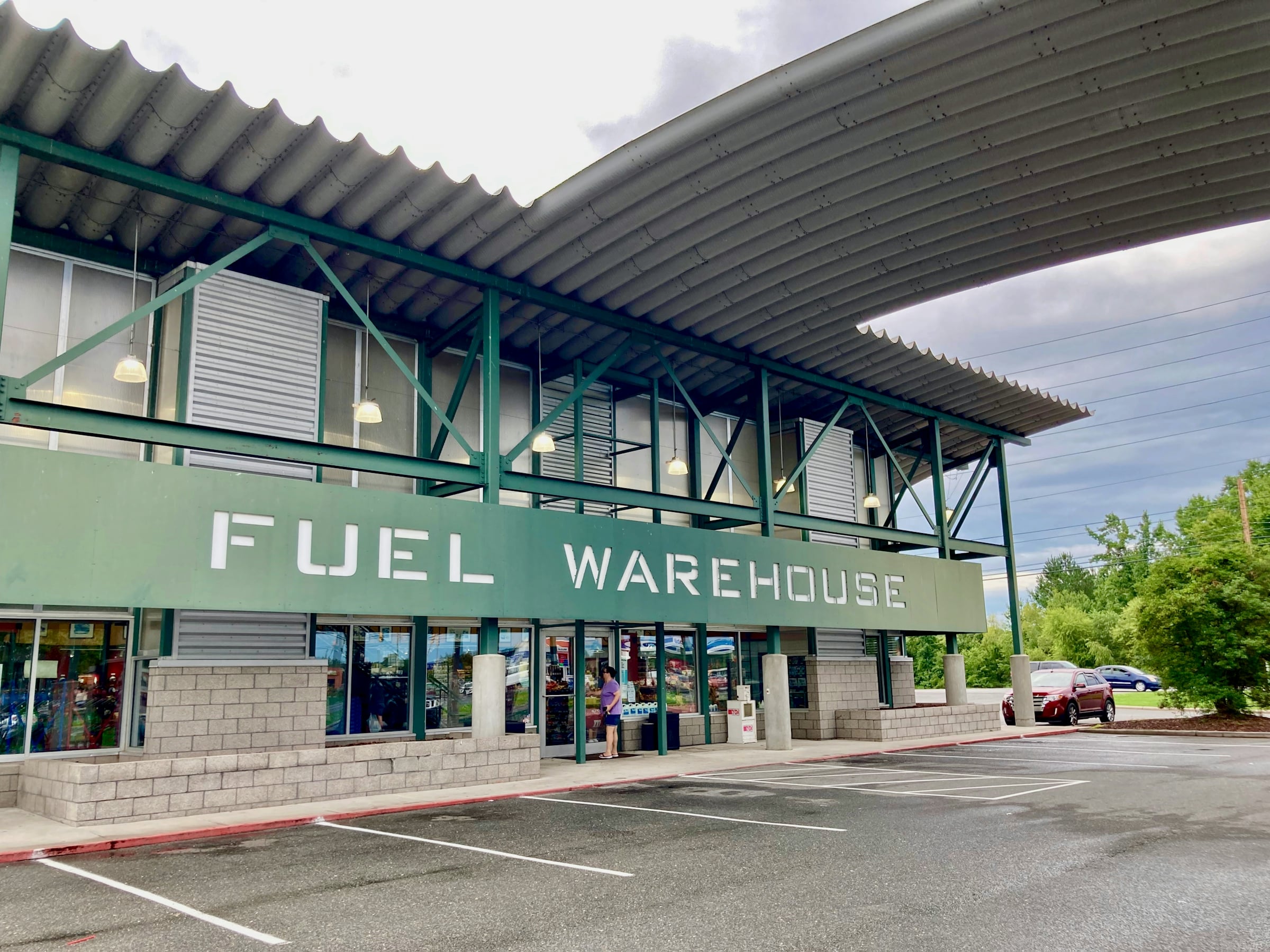 Convenience store and gas pumps under a canopy roof