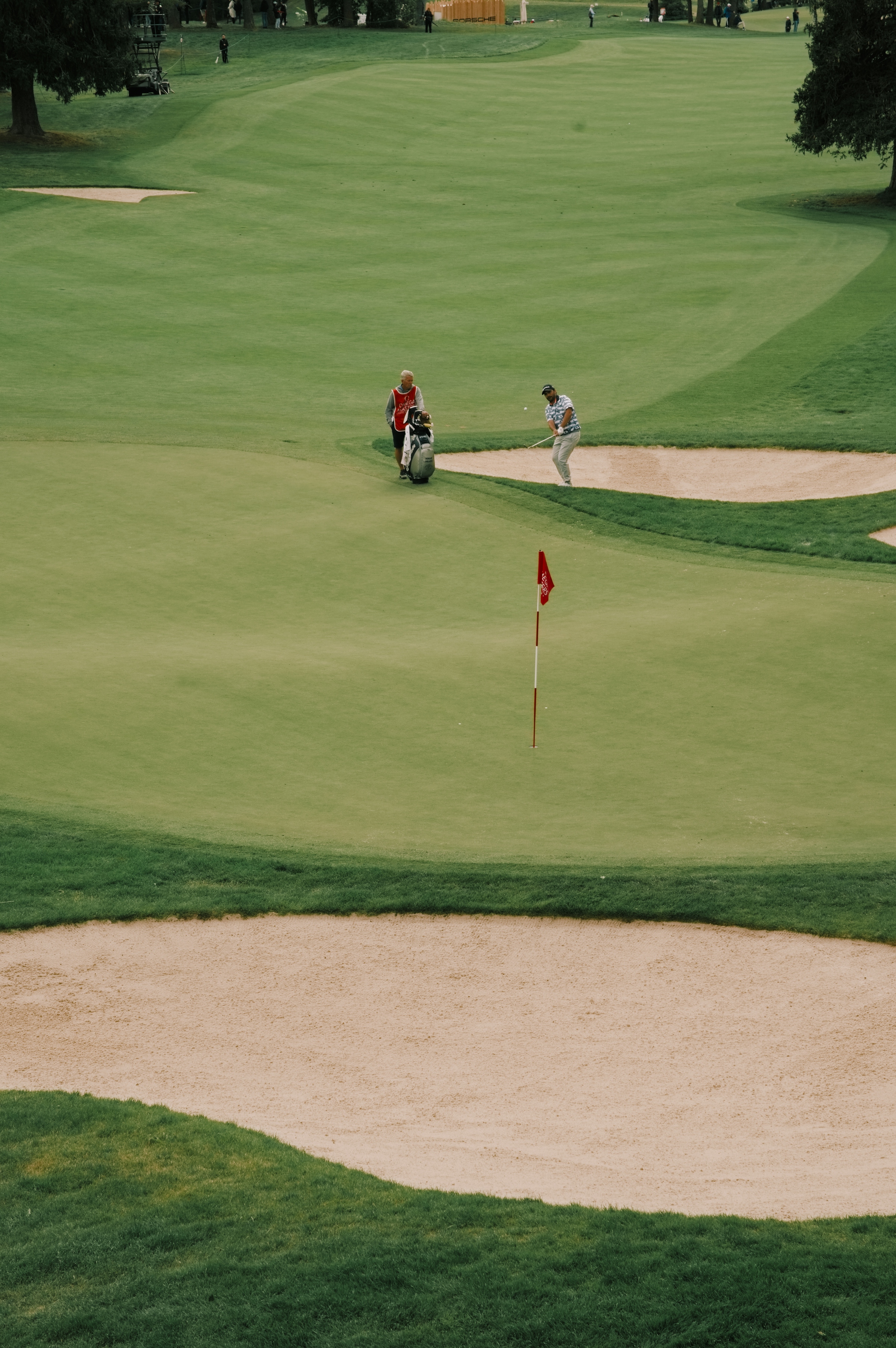 A closely mown putting green with the pin flag standing at the hole.
