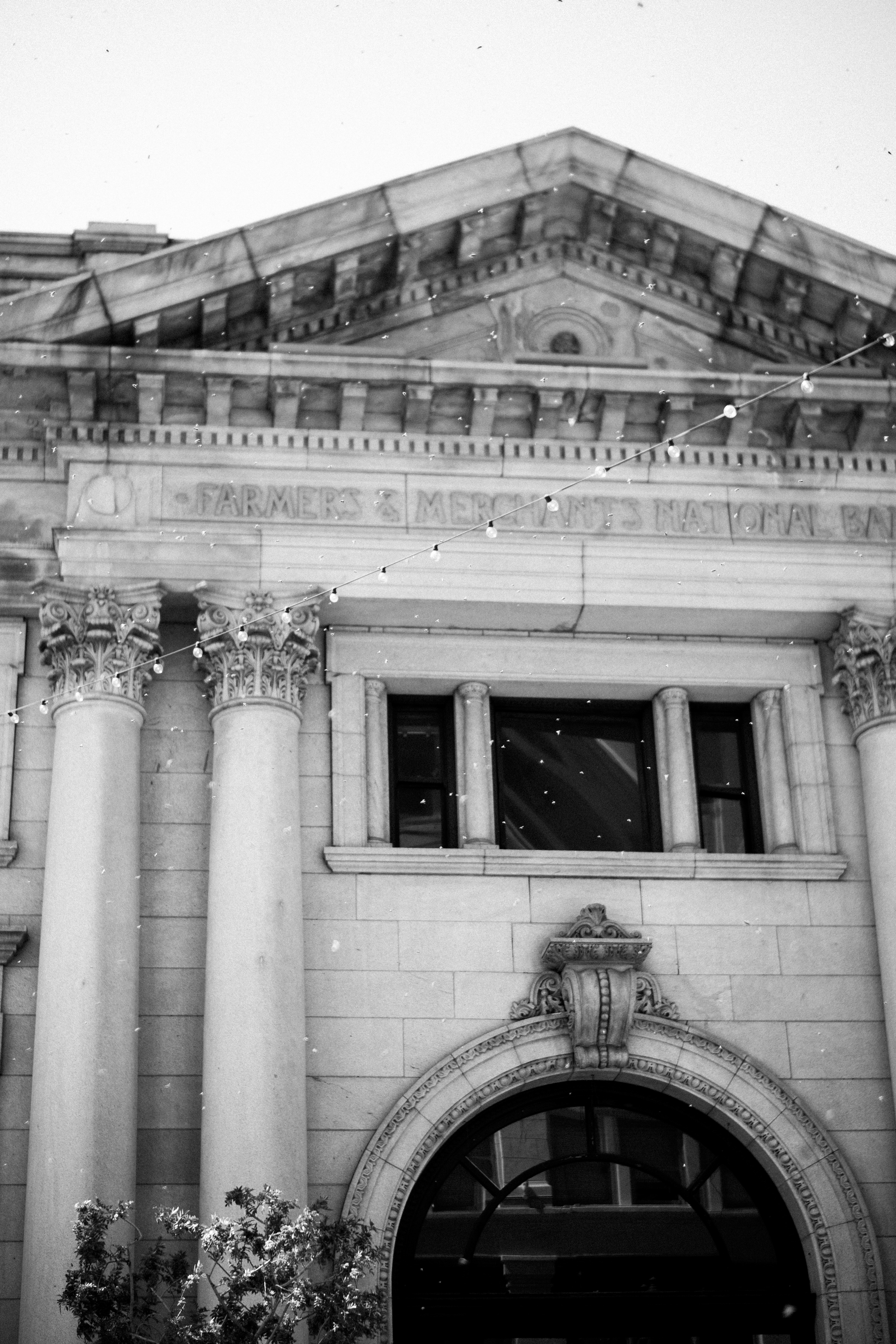 A historic building facade with tall columns and an arched entrance