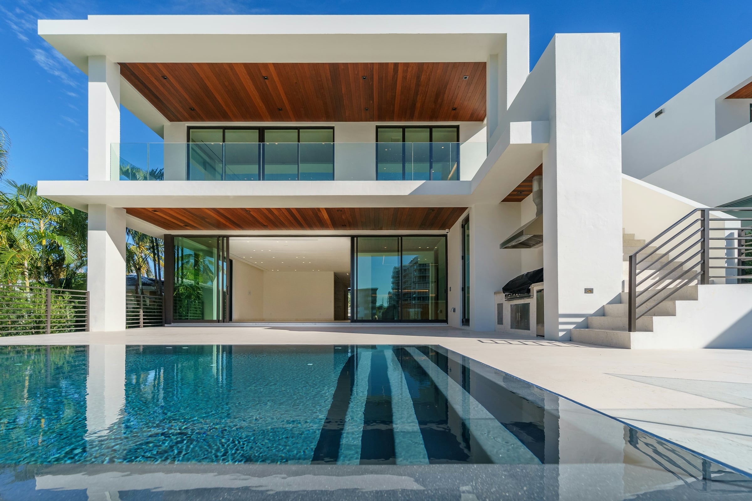 Modern white two-story house with a pool
