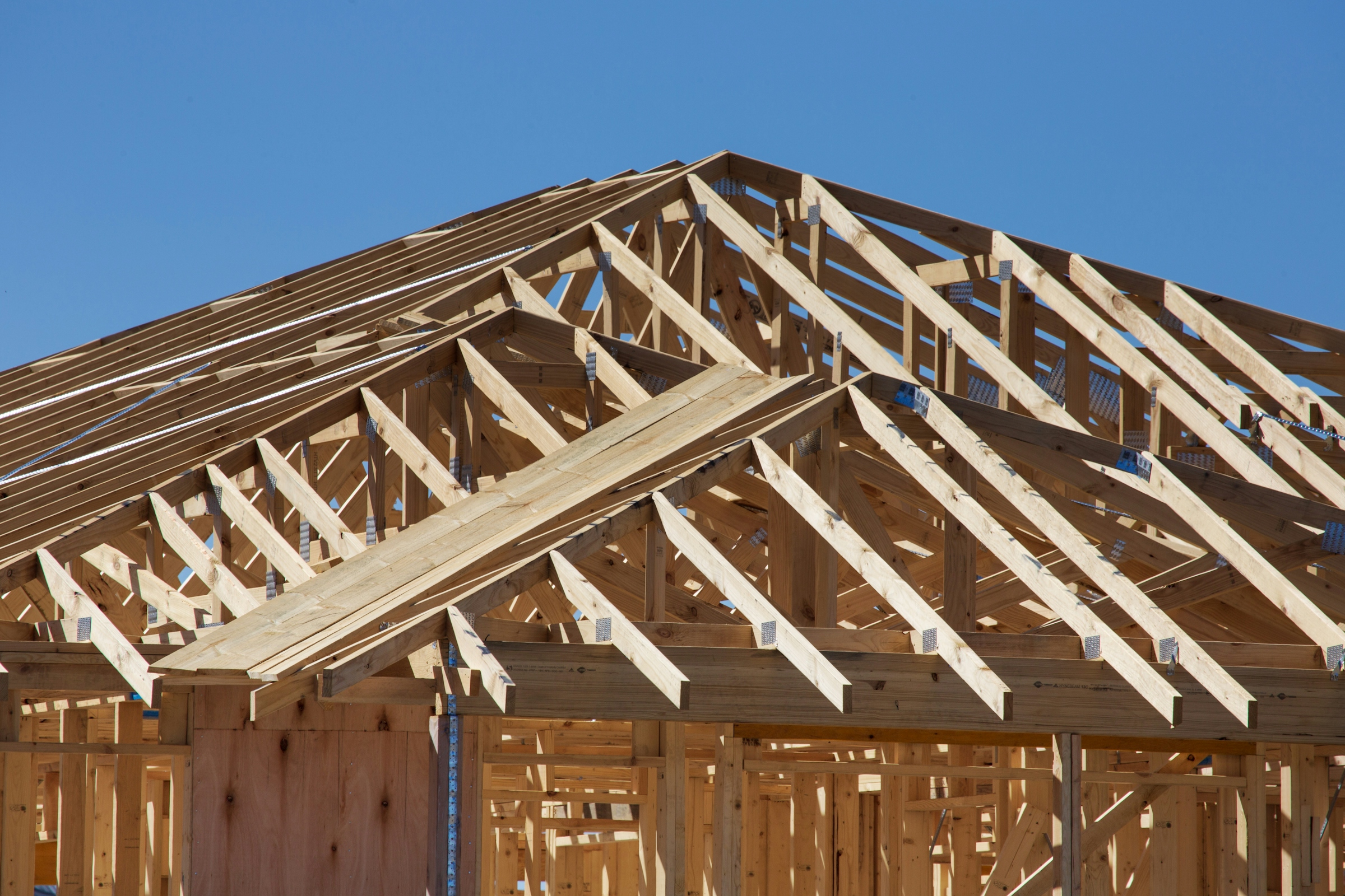 Wooden roof trusses framed out over a house under construction