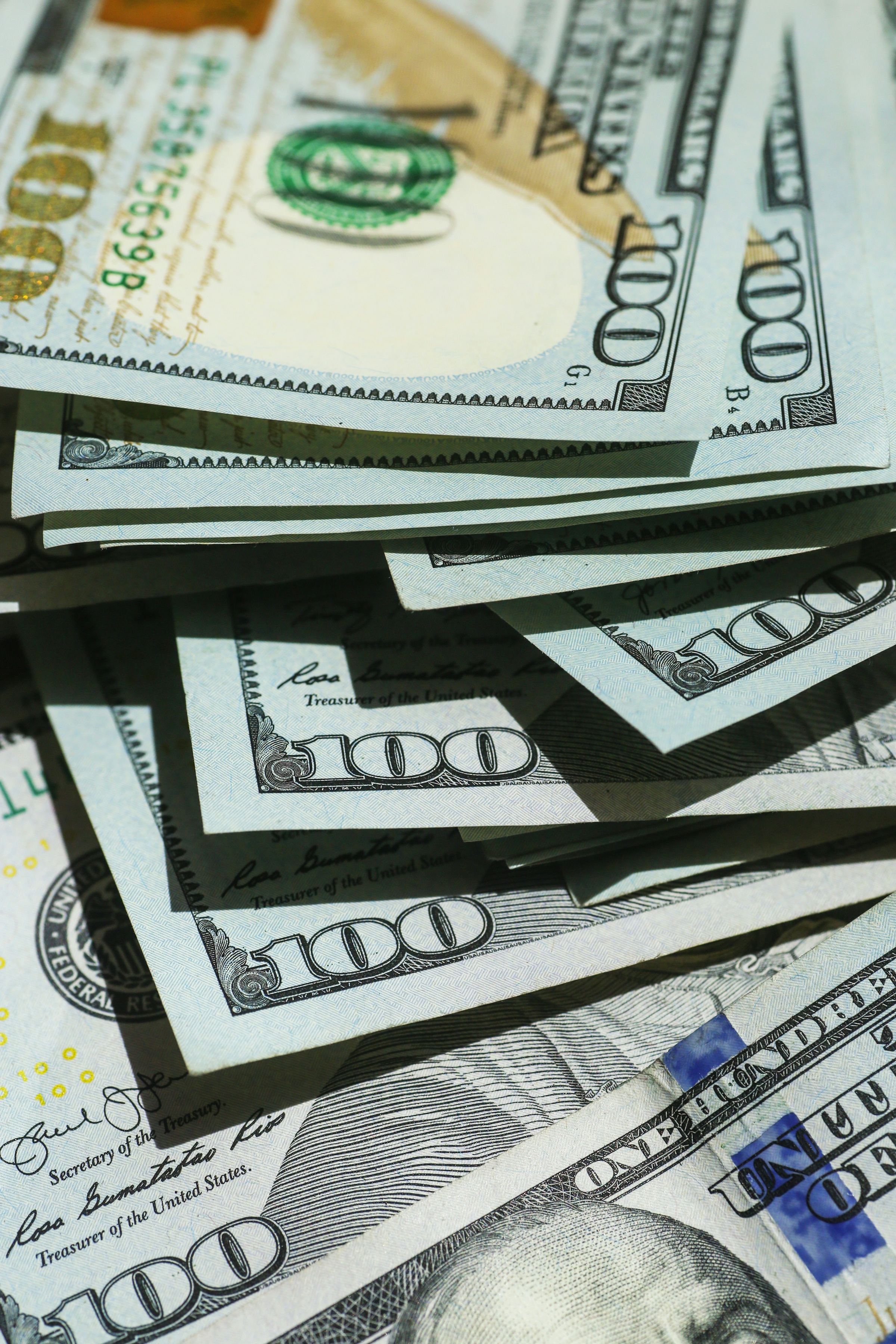 A close view of neatly stacked hundred dollar bills