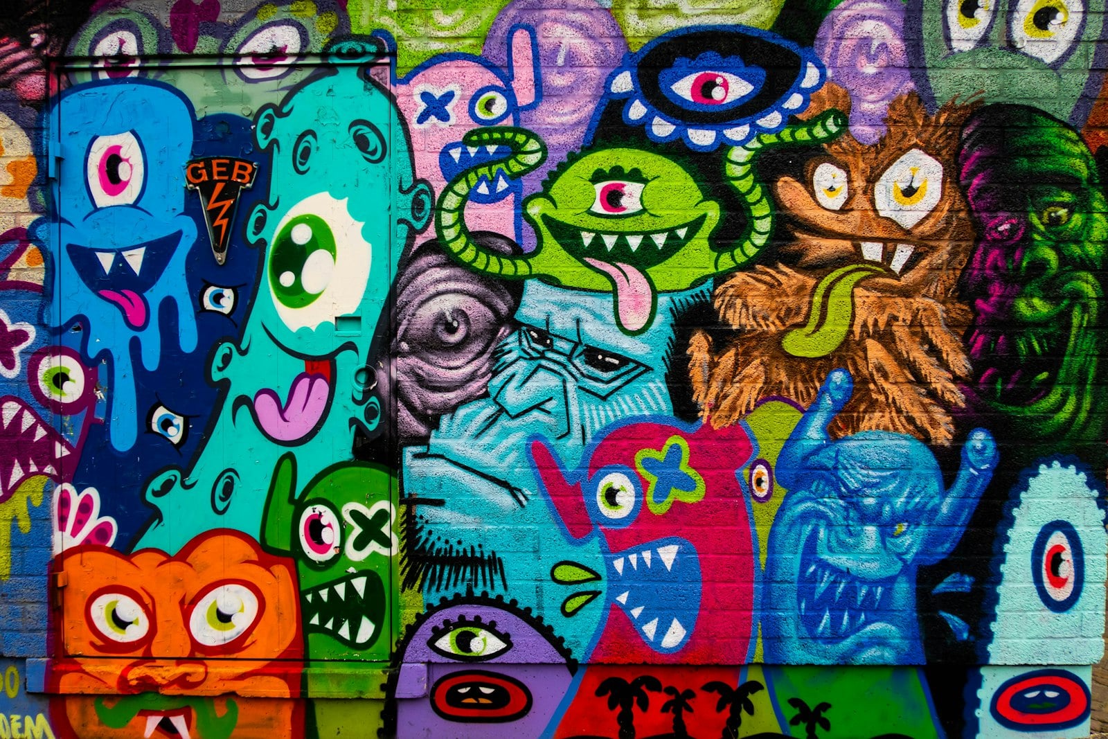 Colorful street mural of cartoon monsters on a wall