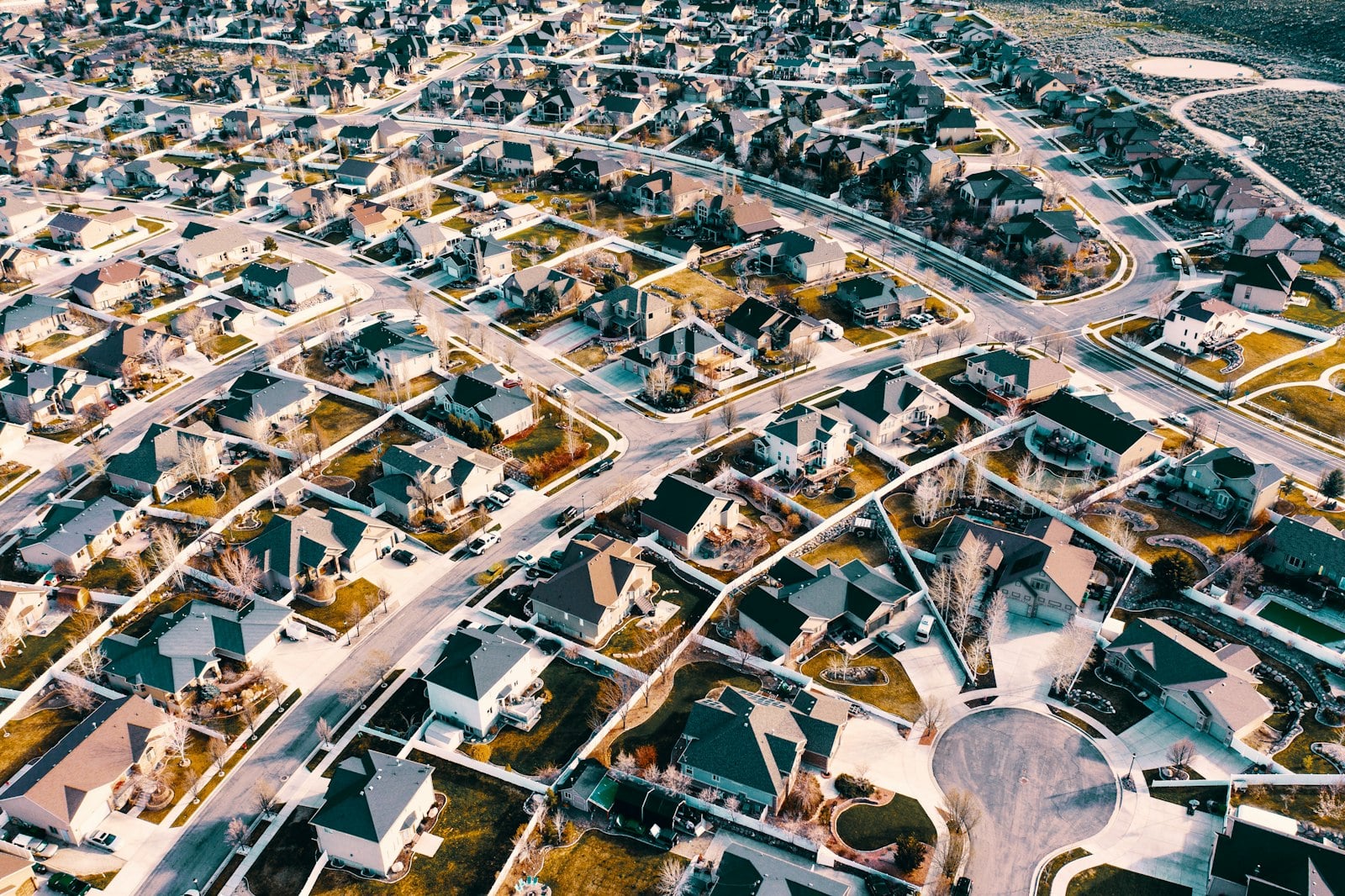 Aerial view of a suburban neighborhood with winding streets and single-family homes