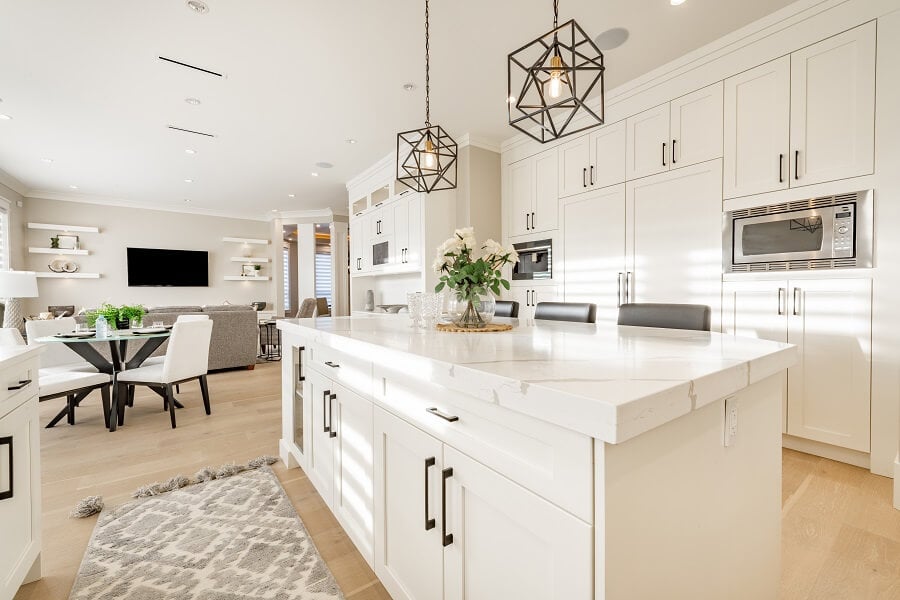 Warm white kitchen with expansive countertops island