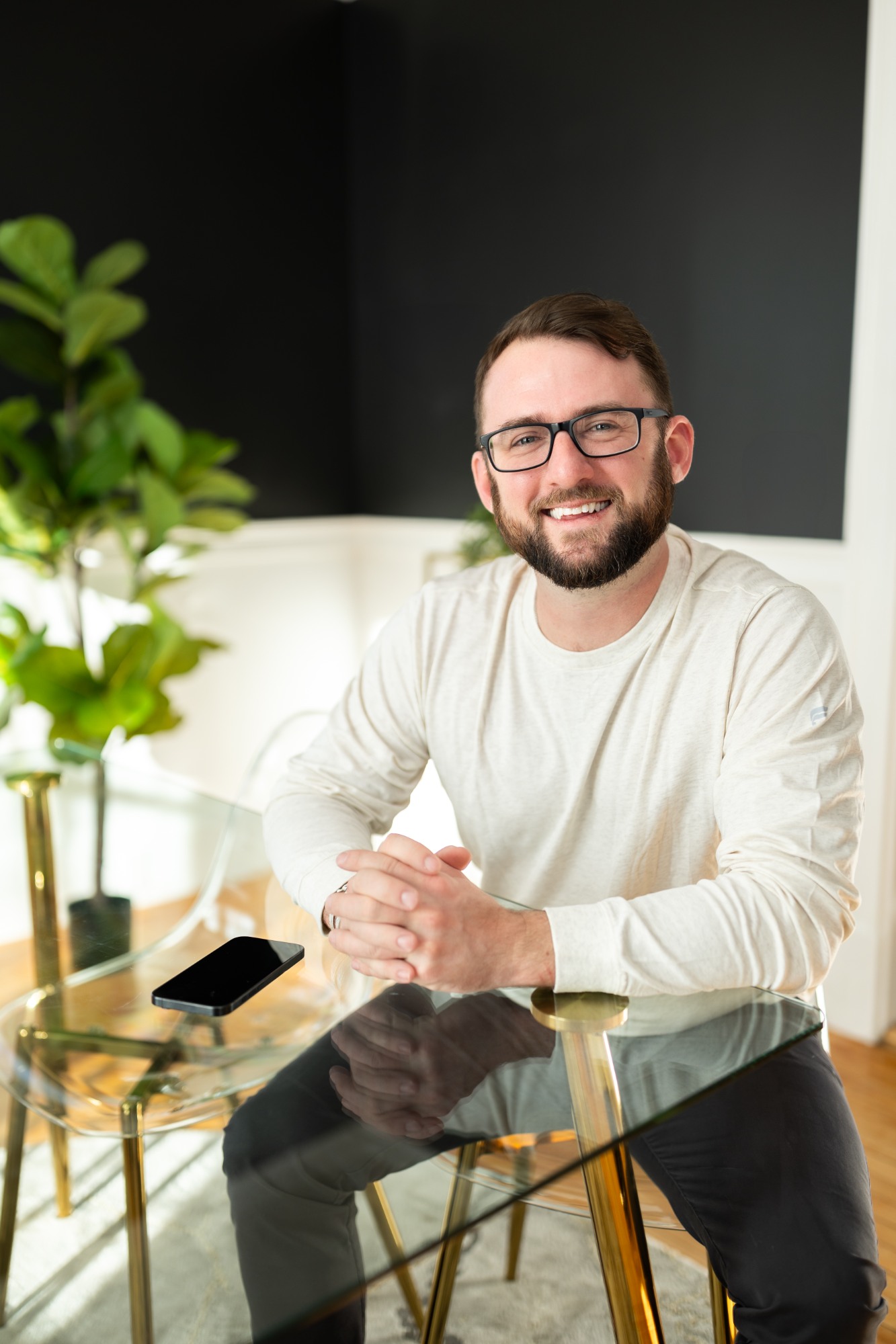 smiling man glass desk