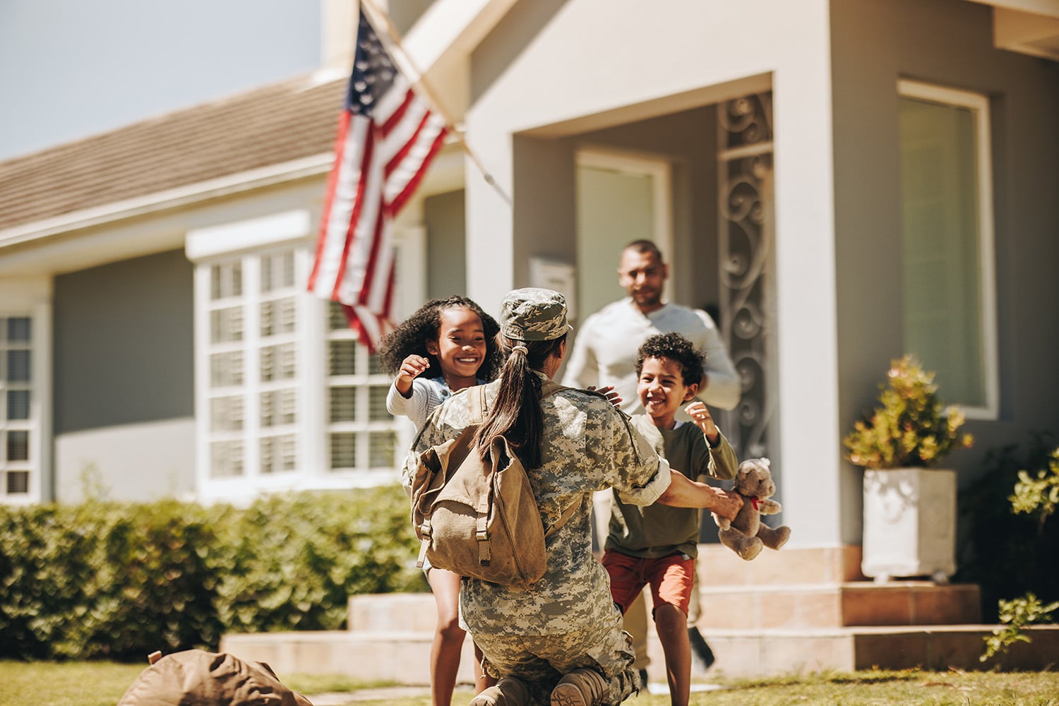 Servicewoman,Embracing,Her,Children,After,Arriving,Home,From,The,Army.