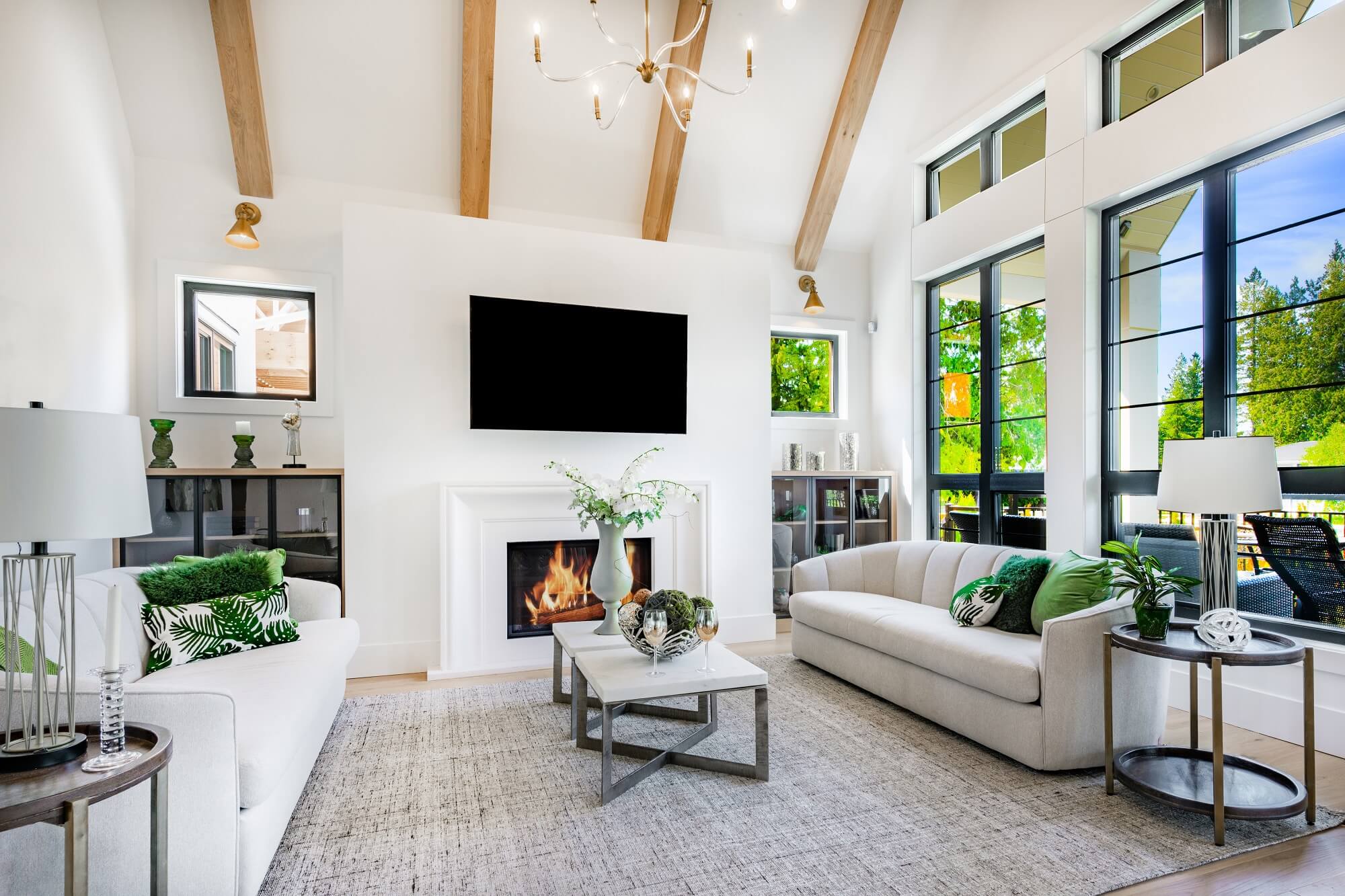 Modern farmhouse style living and family room with large windows cabinets in blues and greens