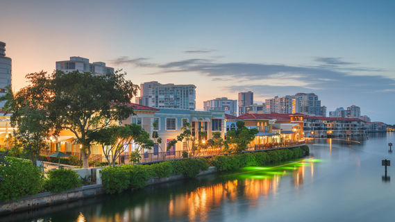 Naples - Naples, Florida, USA town skyline on the water at dawn