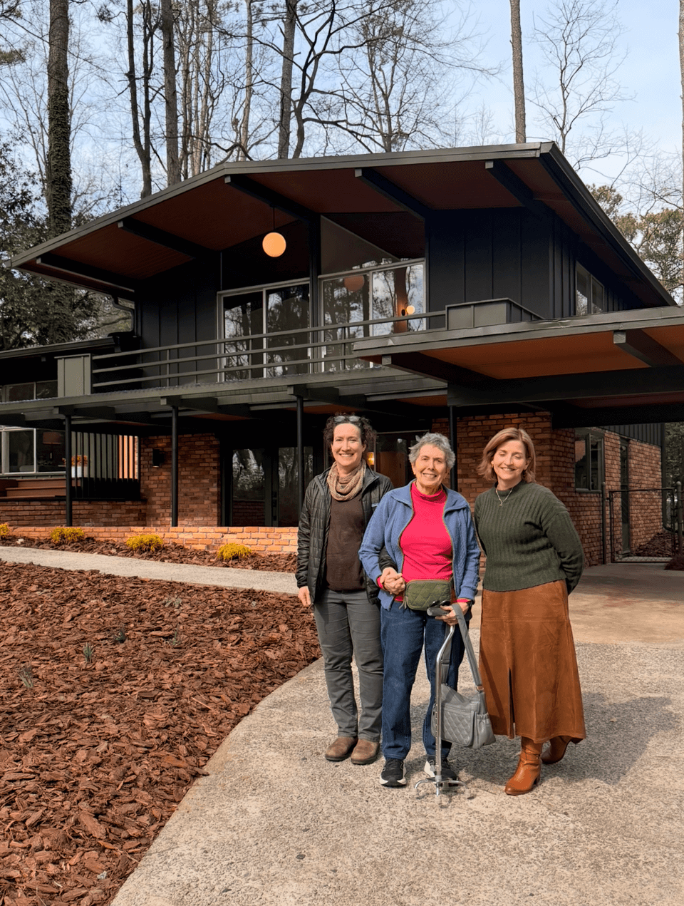 Women in front of a Mid Century moderm home