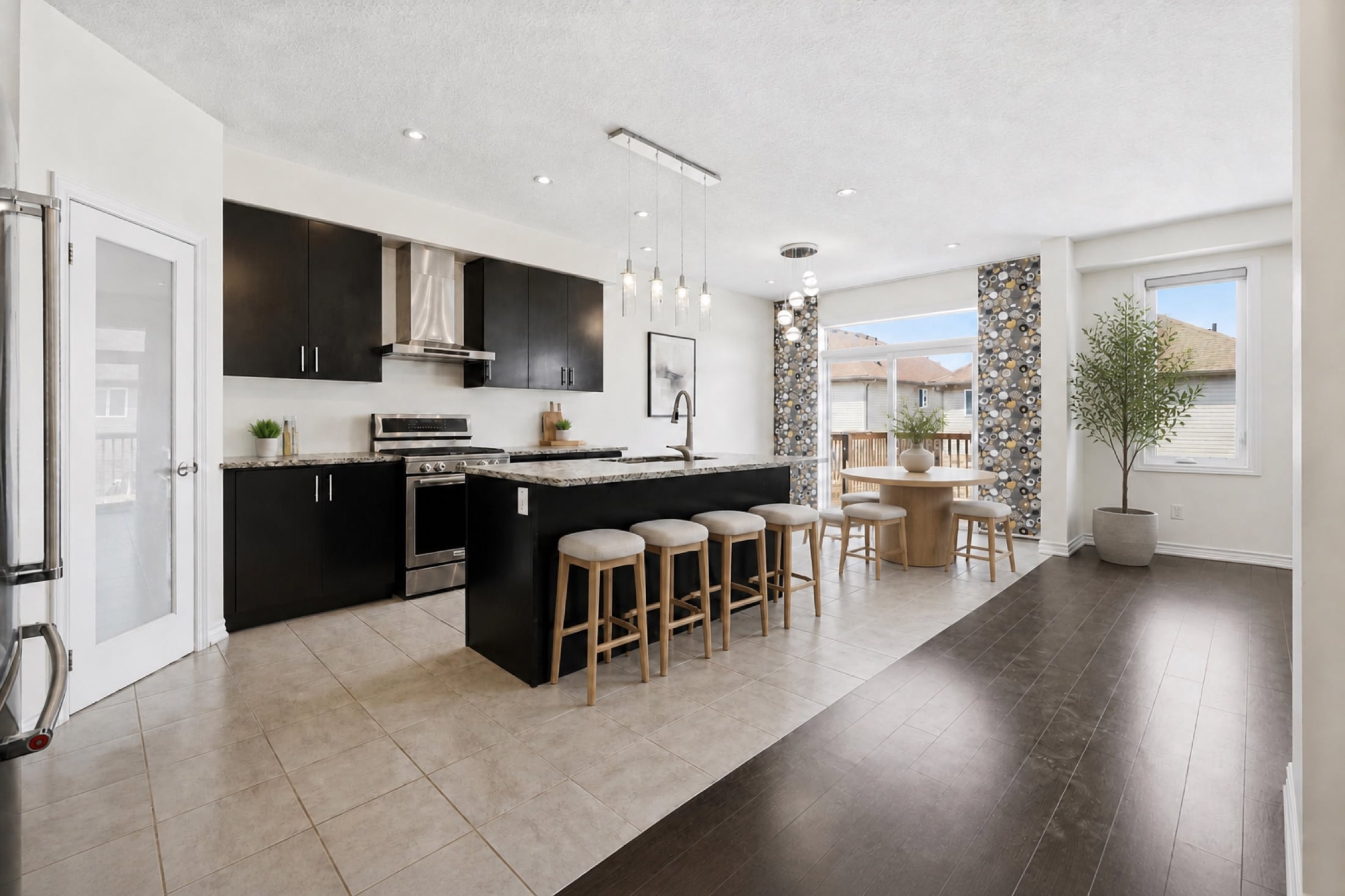 Virtually staged kitchen with dark cabinetry, granite counters and island seating